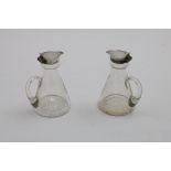 A PAIR OF EARLY 20TH CENTURY MOUNTED GLASS WHISKY TOTS with conical bodies and star-cut bases, by