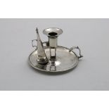 A GEORGE III CIRCULAR CHAMBERSTICK with a rope border, conical snuffer & detachable nozzle, all