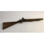 A FLINTLOCK BLUNDERBUSS. A flintlock blunderbuss with associated brass barrel and stock, possibly of