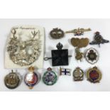 A GORDON HIGHLANDERS CAP BADGE AND OTHERS. A Gordon Highlanders white metal cap badge and a