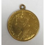 A GOLD FIVE RUPEE COIN. A Queen Victoria Gold 5 Rupee Coin dated 1870. With attached suspension