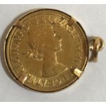 A SOVEREIGN. An Elizabeth II Sovereign dated 1963 in a loose fitting unmarked mount for