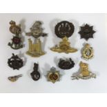 A COLLECTION OF REGIMENTAL CAP BADGES. A collection of fourteen badges to include