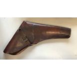 A LEATHER PISTOL HOLSTER. A large leather pistol holster with buckle and strap fastening, probably