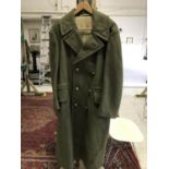 A BRITISH ARMY GREAT COAT. A British Army Greatcoat with brass buttons, the lining stamped 3 700 M E