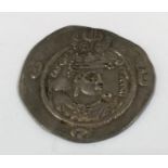 A MIDDLE EAST HAMMERED COIN. A silver coin of the Sasaniad Kings, from Iran/Persia. Moon and