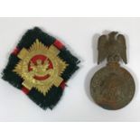 A SOUTH AFRICAN ARTILLERY OFFICERS HELMET PLATE. A helmet badge with conjoined initials ZAR within