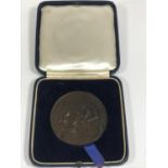 A DAILY MIRROR DIAMOND JUBILEE MEDAL BY P. VINCZE. A bronze medal, the obverse with two workers by a