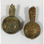TWO BRASS BUSBY BADGES. A Royal Artillery Busby Officer's Plume Badge with King's Crown and