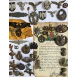 A COLLECTION OF MILITARY BADGES AND INSIGNIA. A large collection of military insignia and badges,