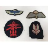 CLOTH BADGES INCLUDING S.A.S. PARACHUTE WINGS. A collection of four cloth badges comprising an SAS