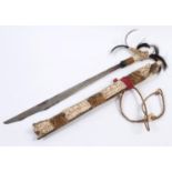A BORNEO HEAD HUNTERS SWORD. A highly decorative head hunters sword, the grip with three plumes of