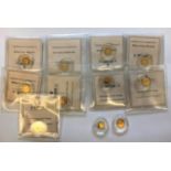 ELEVEN 14ct MINIATURE GOLD 'COINS'. Each 0.5g, nine with certificates confirming .585 purity,