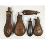 A COLLECTION OF SHOT FLASKS. Five assorted flasks, three with embossed decoration including a gun