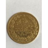 A TURKISH 100 KURUSH COIN. A Gold 100 Kurush coin bearing an Arabic date of 1255. 7.1g.