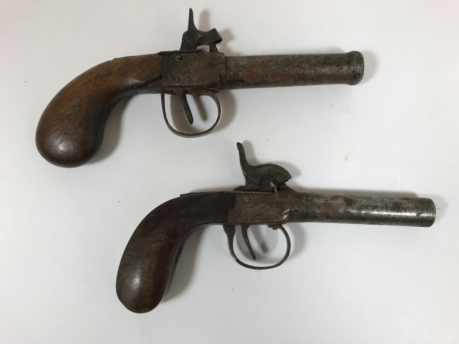 TWO SIMILAR SMALL PERCUSSION CAP PISTOLS. Two Belgian percussion cap pistols with rounded barrels,