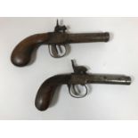 TWO SIMILAR SMALL PERCUSSION CAP PISTOLS. Two Belgian percussion cap pistols with rounded barrels,