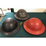 A WORLD WAR TWO POLICE 'TIN HELMET' AND TWO OTHERS. A black finished helmet with white stencilled '