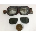 A PAIR OF BOXED R.A.F. GOGGLES. A pair of Second World War goggles with 'dark' lenses and a tin