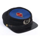 AN AMERICAN KEPI TYPE CAP. An American Blue and black wool Kepi by M.C. Lilley & Co. Manufacturers