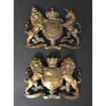 TWO HERALDIC BRASS MOUNTS. Two brass heraldic mounts, one the Royal Coat of Arms flanked by lion and