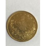 A TURKISH 100 KURUSH COIN. A Gold 100 Kurush coin bearing an Arabic date of 1277. 7.1g.