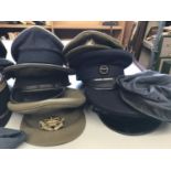 A COLLECTION OF MILITARY CAPS, BERETS AND HATS. A collection of military hats including Navy, Army