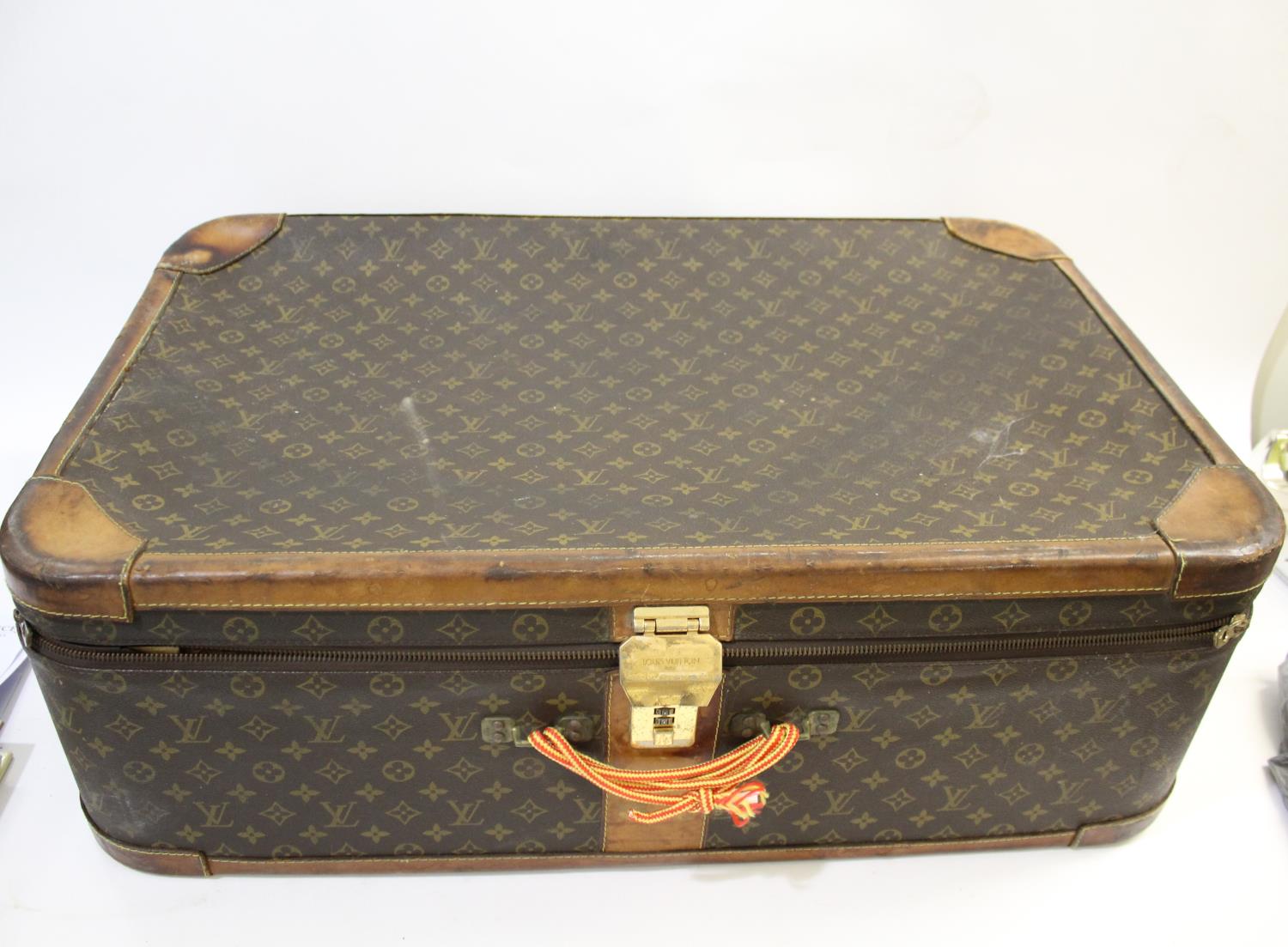 MODERN LOUIS VUITTON SUITCASE with a monogrammed exterior and leather trim, with a combination