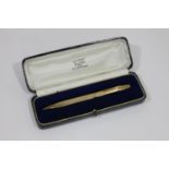 9CT GOLD PEN a 9ct gold ball point pen with engine turned decoration, in a fitted box and marked for