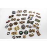 A QUANTITY OF COSTUME BUCKLES mainly 20th century & gilt metal / brass, each one set with paste or