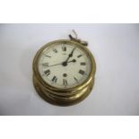 SHIPS CLOCK a ships clock with a brass case and a white enamel dial, with 2 keys and in working