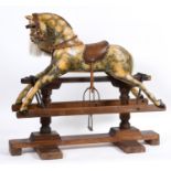 ANTIQUE ROCKING HORSE a small painted wooden rocking horse, mounted on a pine treadle base. Fitted