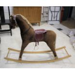 MODERN ROCKING HORSE by Davies of Liverpool, the horse fitted with saddle and bridle. On a wooden