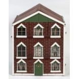 VICTORIAN DOLLS HOUSE a 3 storey house with attic rooms, with a brick facade and glazed windows with