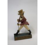 JOHNNIE WALKER ADVERTISING FIGURE - SHOP DISPLAY a composition figure mounted on a wooden base,