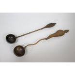 TREEN LADLES probably both 19thc and made in fruitwood, one spoon with a straight shaft and ovoid