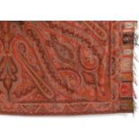 19THC PAISLEY SHAWL a woven wool Paisley shawl, with a rich palette of reds, orange and pale