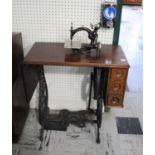 WILLCOX & GIBBS TREADLE SEWING MACHINE a small cast iron sewing machine mounted on a folding