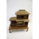 JAPANESE DOLLS HOUSE an early 20thc wood and wicker Japanese dolls house on stand, with an