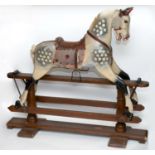 ANTIQUE ROCKING HORSE a painted wooden rocking horse, fitted with a leather saddle and stirrups