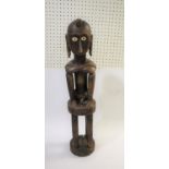 LARGE TRIBAL FIGURE - TIMOR a large carved figure with elongated ears and inset bone eyes, in a