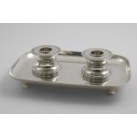 A GREAT WAR PERIOD INKSTAND on a dished rectangular base with rounded corners and bracket feet,