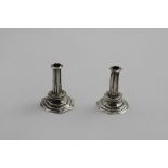 A PAIR OF QUEEN ANNE MINIATURE OR TOY CANDLESTICKS on stepped octagonal bases with fluted columns