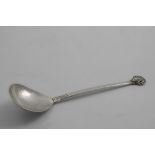 AN EARLY 20TH CENTURY HANDMADE SPOON with a pear-shaped bowl, a cast scallop shell terminal and a
