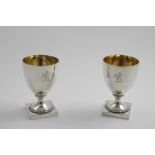 A PAIR OF GEORGE III WINE GOBLETS on square pedestal bases, crested, gilt interiors, by Thomas