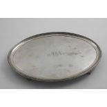 A GEORGE III OVAL SALVER with a reeded border and four reed-bordered bracket feet, engraved in the