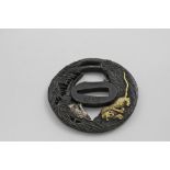 A DECORATIVE BRONZE TSUBA pierced with fighting tigers amongst foliage, heightened with plating