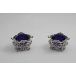 A PAIR OF EARLY VICTORIAN CAST OPENWORK SALTS incorporating the original owner's coronet and
