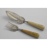 A PAIR OF EDWARDIAN FISH SERVERS with pierced and engraved decoration and ivory handles carved