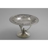 AN EDWARDIAN ARTS & CRAFTS TAZZA on a rising foot with a hammered finish and three cast scroll